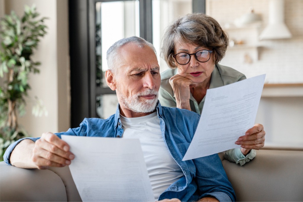 An elderly couple looking over documents for wills, trusts, and estate planning in Central Florida
